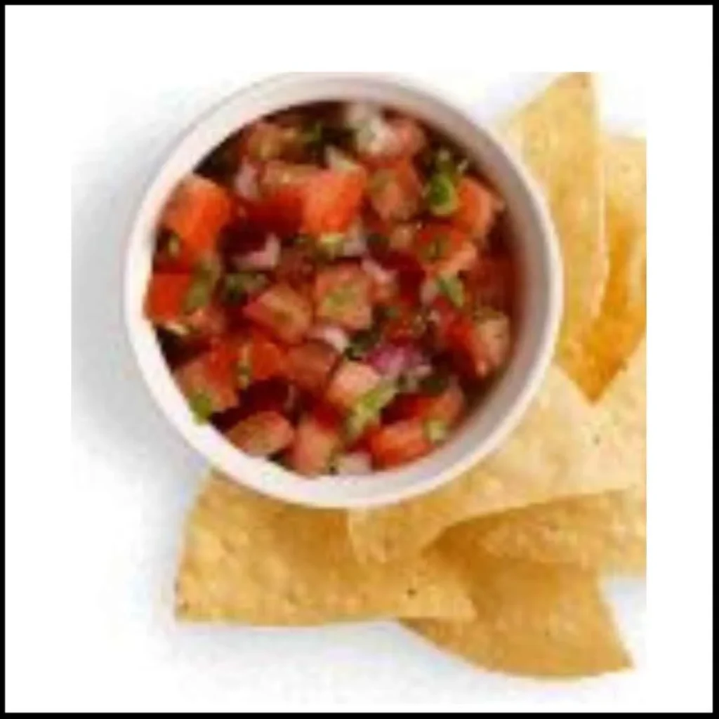 Fresh Tomato Salsa with Tortilla Chips – A Delicious Snack A bowl of fresh tomato salsa with diced tomatoes, onions, and green peppers, served with crispy tortilla chips.