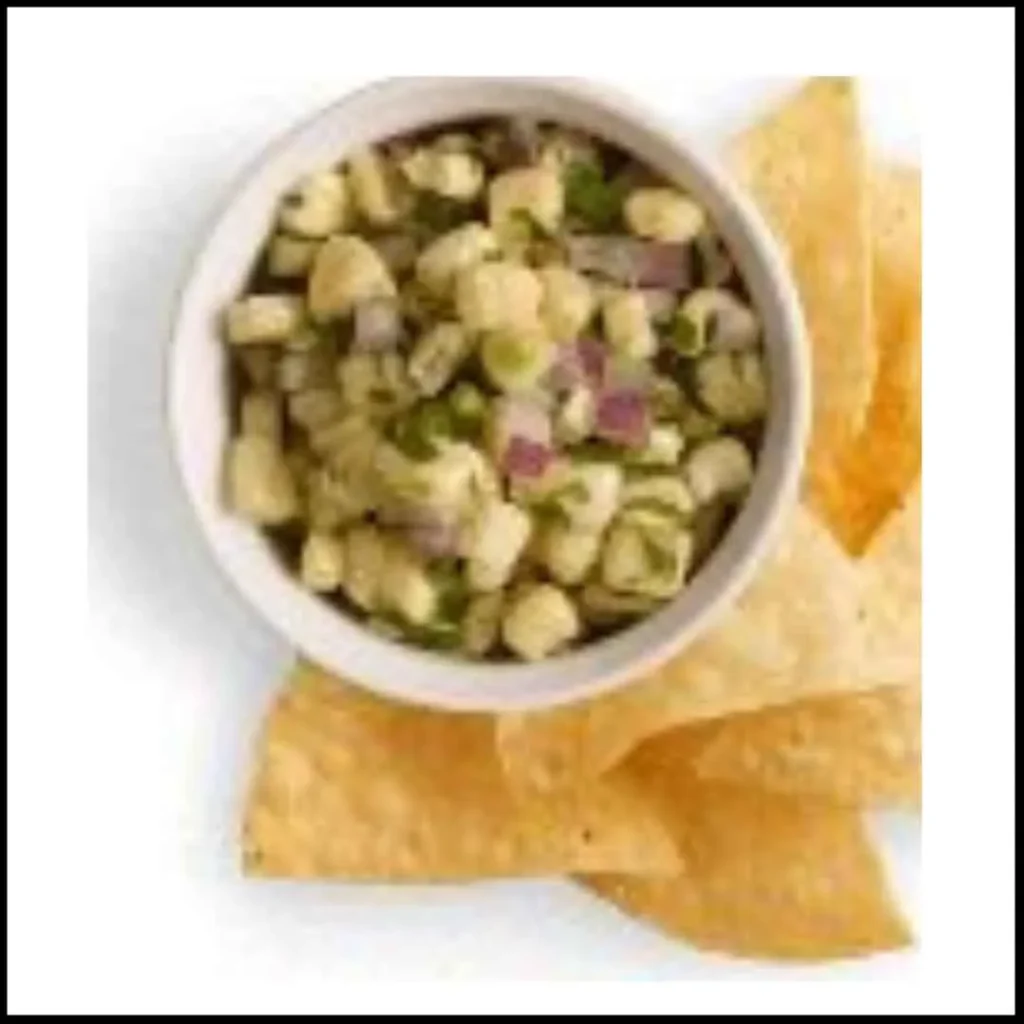 Roasted Chili-Corn Salsa with Tortilla Chips – A Flavorful and Crunchy Snack A bowl of roasted chili-corn salsa with diced red onions, jalapeños, and herbs, served with crispy tortilla chips.
